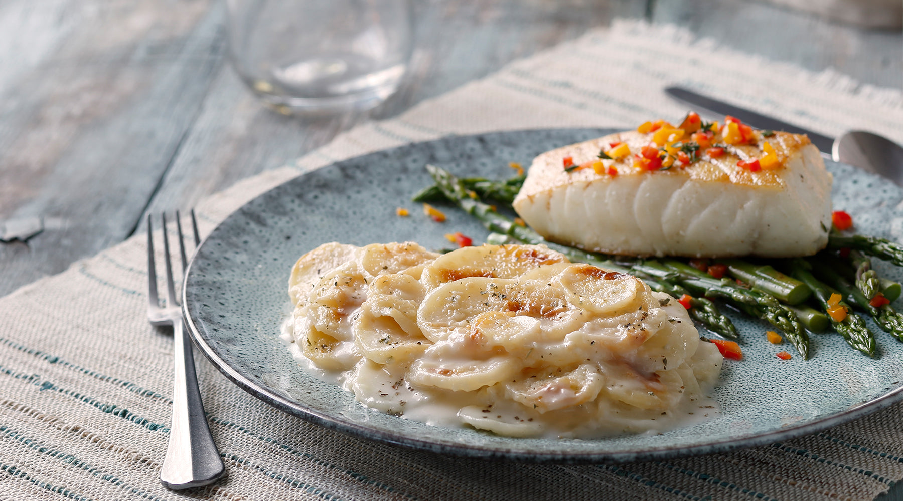Idahoan Cheesy Scalloped Casserole on a plate served with fish