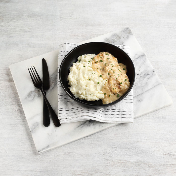 Image of cooked and plated Idahoan® Butter & Herb Mashed Potatoes Family Size